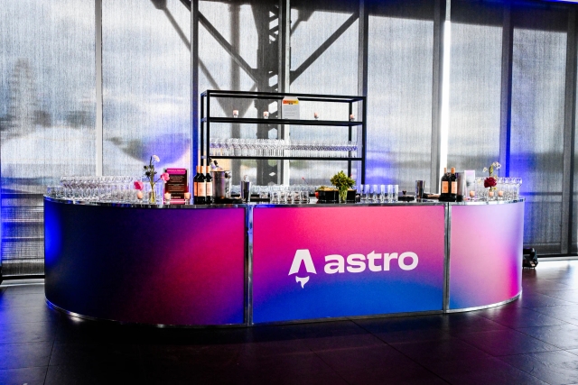 Vibrant blue and red alcohol bar with the Astro logo across it in white.