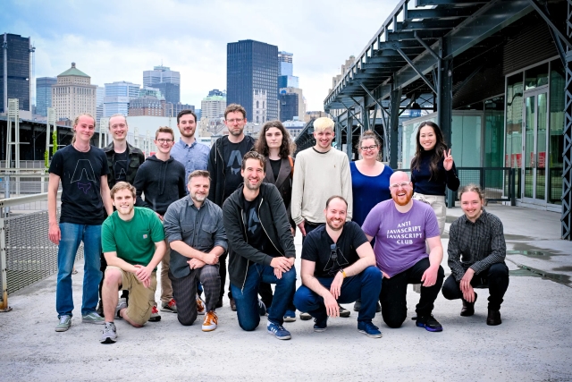 The Astro core team poses outside the meetup venue with the Montreal skyline behind them.