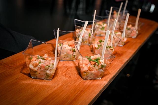 A paddle board of salmon tartare appetizers.