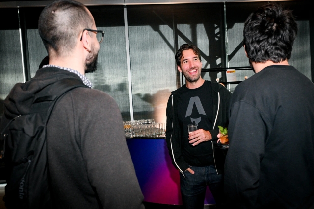 Fred, steward of the Astro project, laughing with guests.