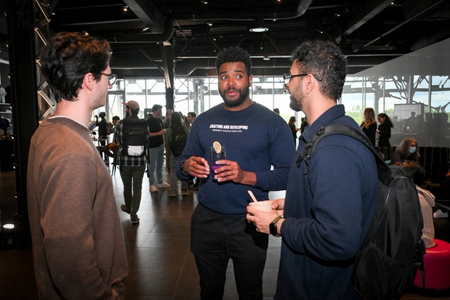 Guests talking to one another holding drinks.