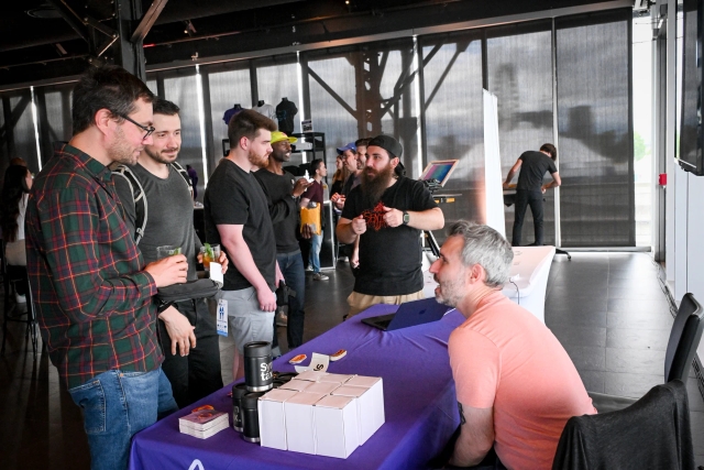 Sentry speaking to guests at their sponsor booth.