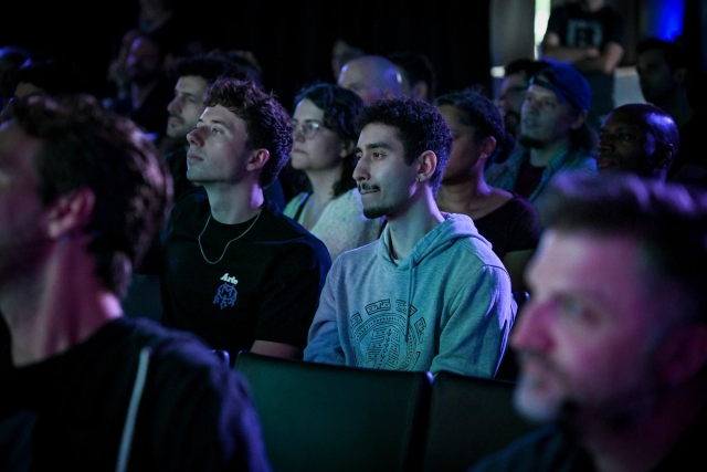 A shot of the crowd listening to Ben Holmes speak on stage.