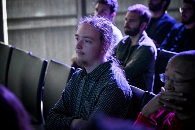 Reuben, a maintainer, intently watching the keynote presentation from the audience.