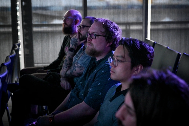 A row of audience members watching the keynote presentation.