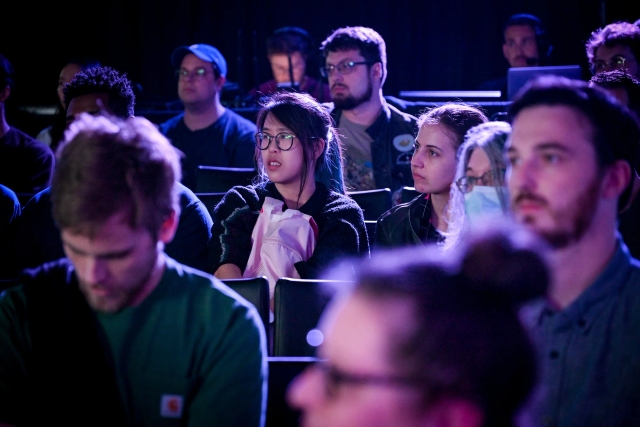 Audience members listening to the keynote speaker.