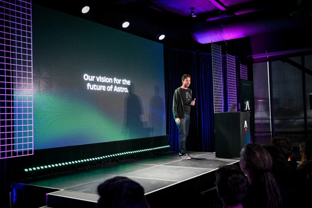 Fred K. Schott speaking on stage next to an Astro-branded podium. He is introducing the team vision for the future of Astro.