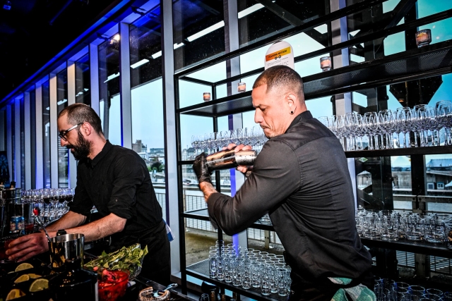 Closeup of a bartender mixing a drink.